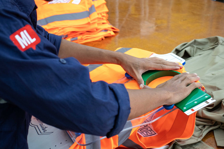 Mr. Loriku staff hooping a hi vis vest for embroidery