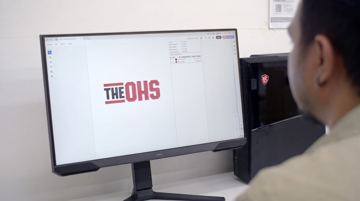 Mr. Loriku designer digitising a customer logo for embroidery on screen